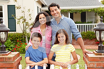 Hispanic family standing outside home