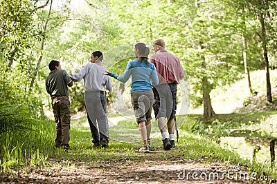 Hispanic family walking along trail in park