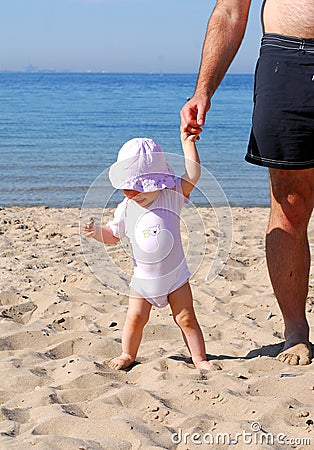 Hold my hand dad to explore the beach