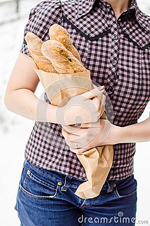 Woman hands holding baguettes