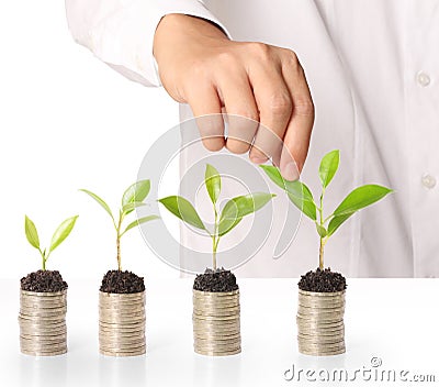 Holding plant sprouting from a handful of coins