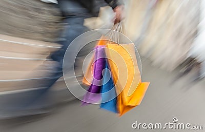 Holiday sales. An elderly man with many shopping bags in his han