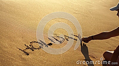Holiday text in clean sand at summer