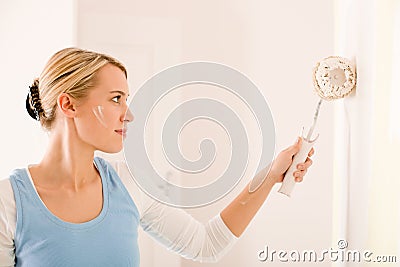 Home improvement - handywoman painting wall