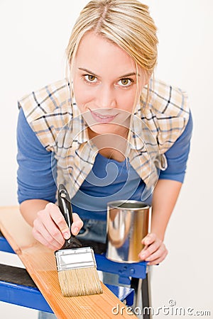 Home improvement - handywoman painting wood