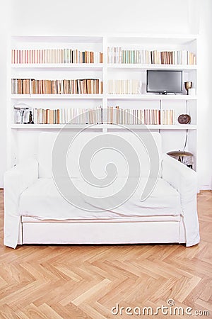 Home library with sofa or couch in white living room