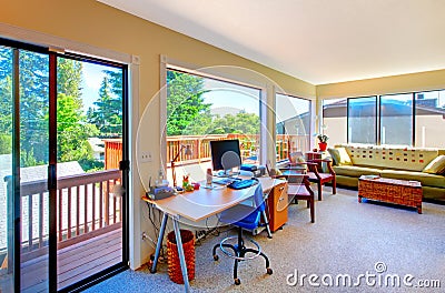 Home office and living room house interior with balcony view.