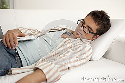 Home Tech Asleep on Sofa with Laptop