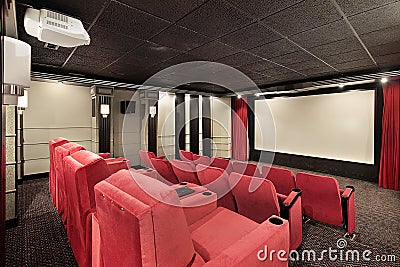 Home theater with red chairs