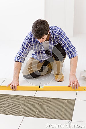 Home tile improvement - handyman with level