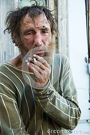 Homeless man smoking cigarette