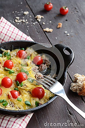 Homemade baked minced meat with cheese and cherry tomatoes