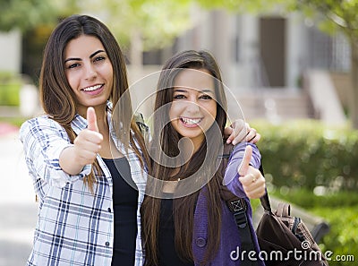 Homosexual Mixed Race Female Couple on School Campus With Thumbs Up