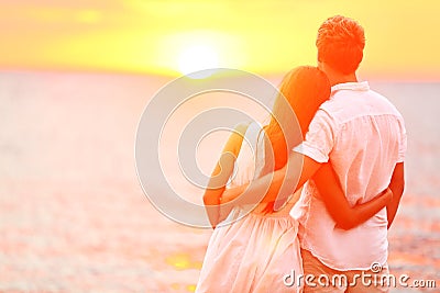 Honeymoon couple romantic in love at beach sunset