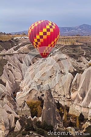 Hot air balloon flying over rock landscape at Cappadocia Turkey