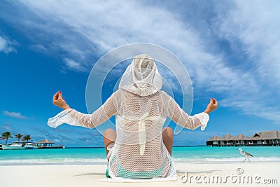 Hot beautiful woman enjoying looking view of beach ocean on hot summer day.