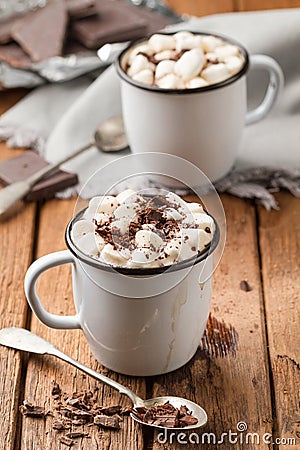 Hot chocolate with marshmallows in two enamel tin mugs