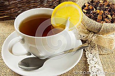 Hot cup of tea and dry herbal leaves