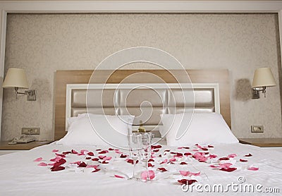 Hotel room with big bed and red flowers