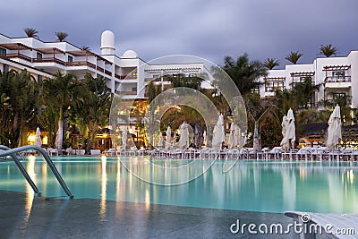 Hotel with swimming pool at dusk