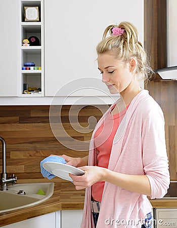 Houesewife washes dishes
