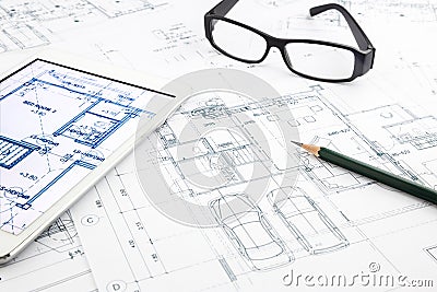 House blueprints and floor plan with tablet