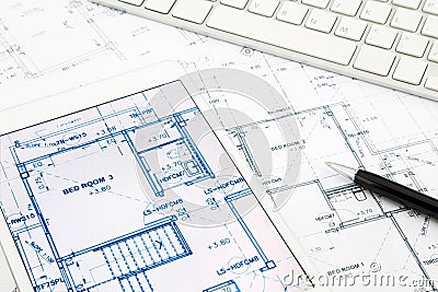 House blueprints and floor plan with tablet