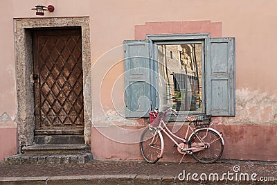 House front with aged nostalgic bike