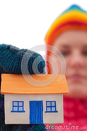 House holds woman in winter gloves