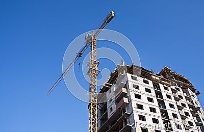 House under construction with construction crane
