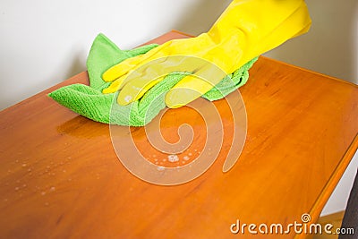 Household, cleaning with rag and gloves.