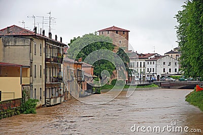 Houses near the shore of the raging river during the flood