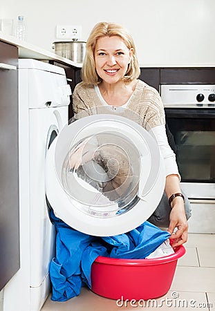 Housewife using washing machine at home