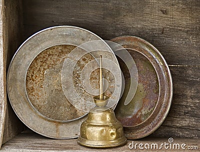 Hubcaps and tall oil can on old garage shelf