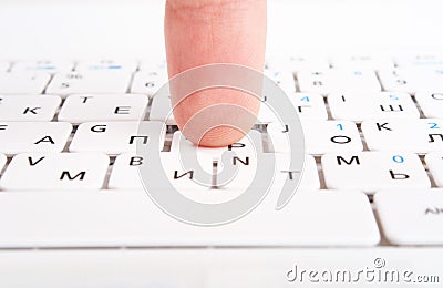 Human finger on a laptop keyboard. Press a key