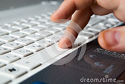 Human fingers on the notebook keyboard