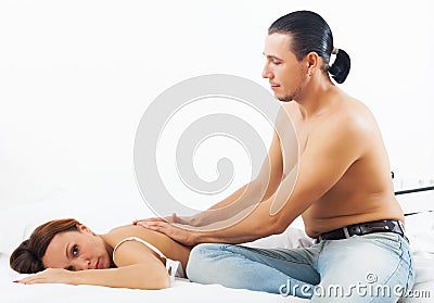 Husband massaging the back of his woman
