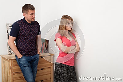 husband wife find out relationship men looks woman leaned against wall turned away 64029973