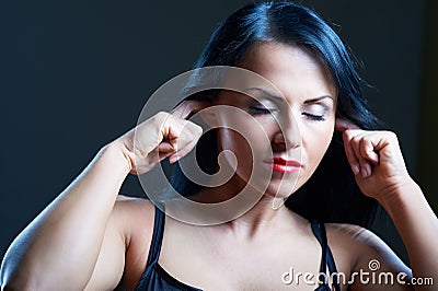 I Can t Hear You. Young woman covering her ears