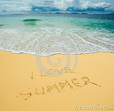 I love summer written in a sandy beach