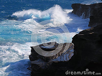 Ice blue tropic wind swell pounds the cliffs, Hawaii