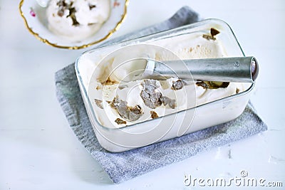 Ice cream scoop in ice box with salty caramel ice cream and truffles