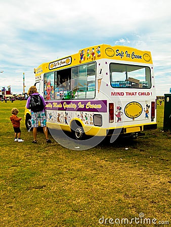 An ice cream van with a mother and child customers