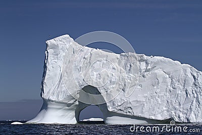 Iceberg with large through the entrance to the ocean off the coa