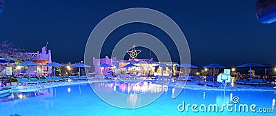 Illuminated swimming pool at night