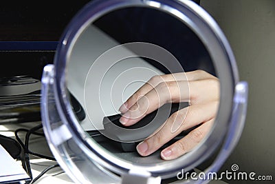 Image of a hand on a mouse reflected in a mirror 1