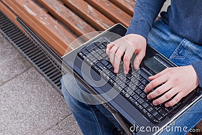 Image of man s hands typing. Selective focus. Outdoors photo.