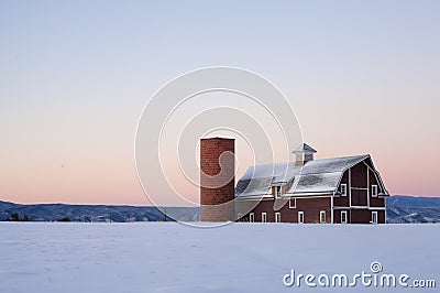 Image of a red barn with a field of snow