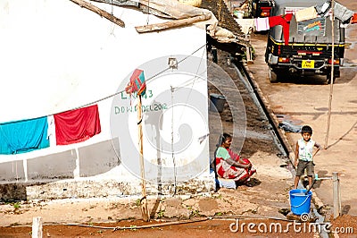 Indian boy and his grandmother near thear house at small poor village