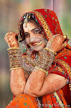 Indian bride in her wedding dress showing bangles